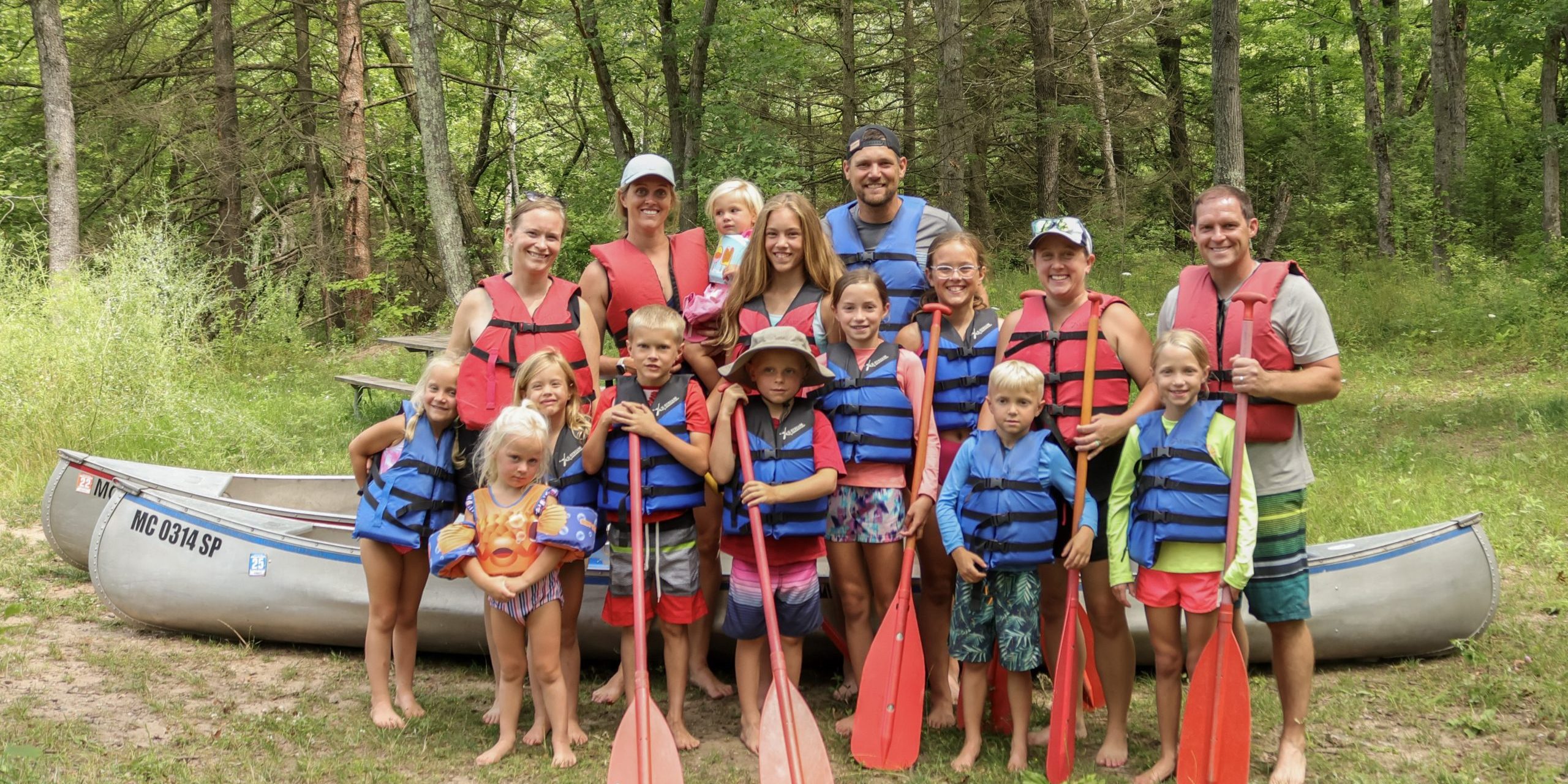 Simple Family Camping Traditions at White River RV Park & Campground Families preparing for a canoe trip with Happy Mohawk Canoe Livery near White River RV Park & Campground in West Michigan