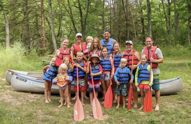 Simple Family Camping Traditions at White River RV Park & Campground Families preparing for a canoe trip with Happy Mohawk Canoe Livery near White River RV Park & Campground in West Michigan