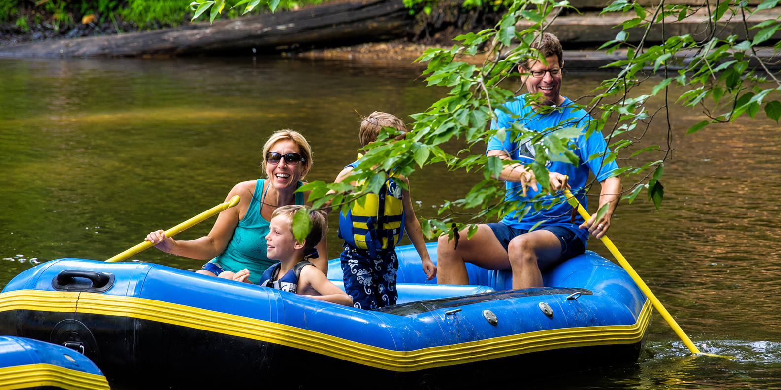 Explore West Michigan from White River RV Park & Campground Family enjoying a rafting trip on the White River near White River RV Park & Campground in West Michigan