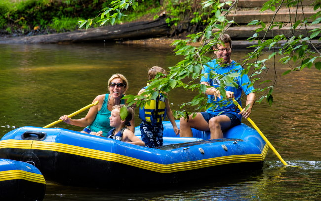 Family enjoying a rafting trip on the White River near White River RV Park & Campground in West Michigan