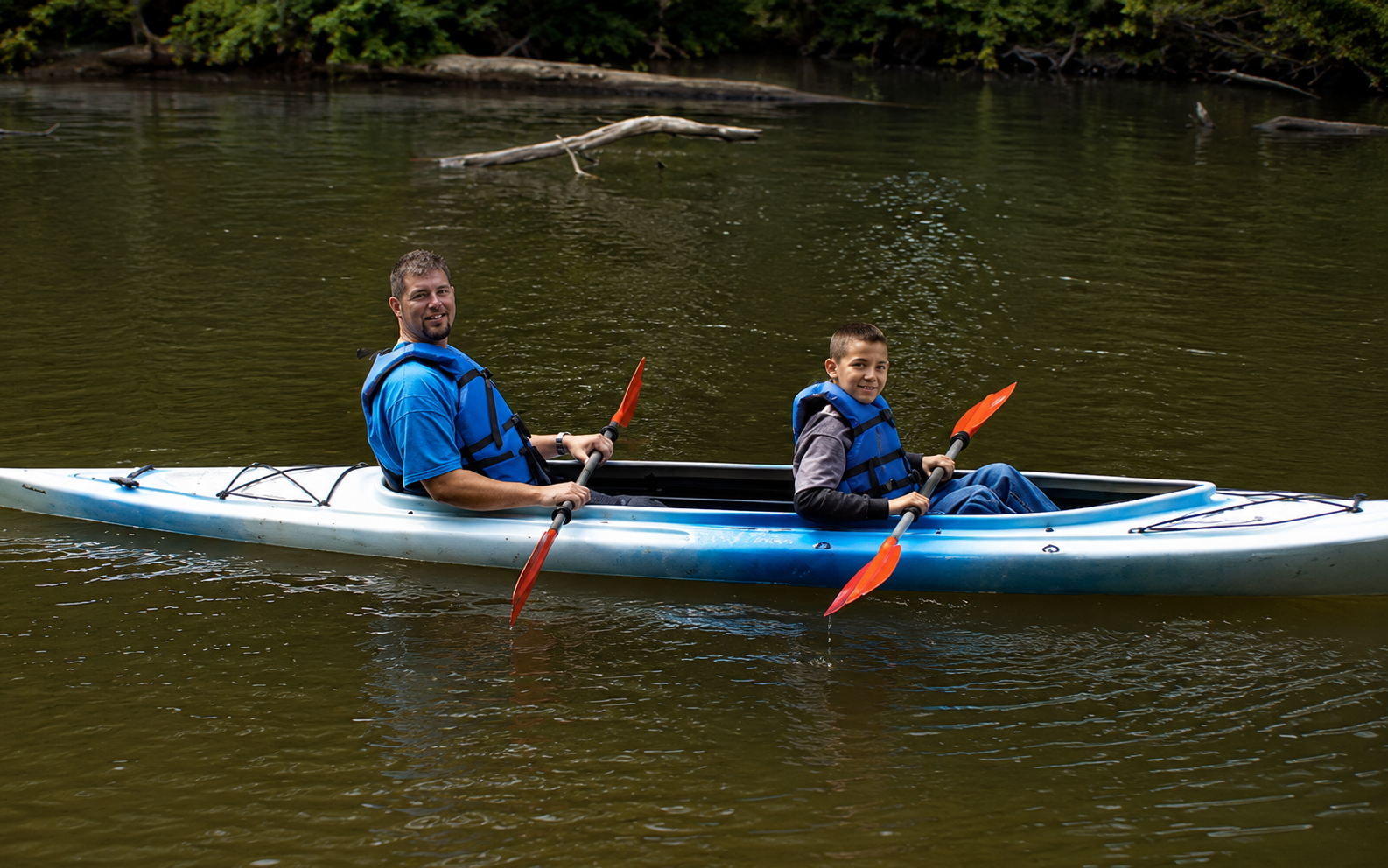 Father and son kayaking on the White River near White River RV Park & Campground in West Michigan