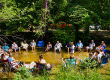 Families relaxing together in the creek at White River RV Park & Campground during a summer camping vacation