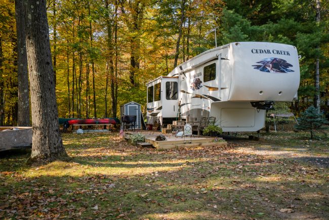 How to Winterize Your RV Before Storage RV campsite surrounded by colorful fall foliage at White River RV Park & Campground before winter storage season